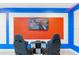 Fun game room with gaming chairs facing a large TV, perfect for immersive entertainment at 2850 Bookmark Dr, Kissimmee, FL 34746