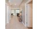 Inviting hallway with neutral tones, leading to the dining and living area, featuring elegant decor and tile flooring at 2850 Bookmark Dr, Kissimmee, FL 34746