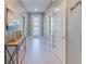 Charming hallway featuring a stylish console table, tile flooring, and modern decor, creating a welcoming entrance to the home at 2850 Bookmark Dr, Kissimmee, FL 34746