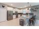 Well-lit kitchen featuring white cabinets, stainless steel appliances, gray countertops, and a stylish backsplash at 2850 Bookmark Dr, Kissimmee, FL 34746