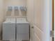 Practical laundry area with a side-by-side washer and dryer, providing convenience and efficiency for daily chores at 2850 Bookmark Dr, Kissimmee, FL 34746