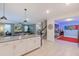 Bright, open-concept living area with a kitchen and vibrant game room, perfect for entertaining guests at 2850 Bookmark Dr, Kissimmee, FL 34746