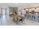 Open-concept living space blending dining and kitchen areas, featuring modern decor, seating, and natural light at 2850 Bookmark Dr, Kissimmee, FL 34746