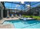 Relaxing screened-in pool and spa area features lounge chairs and a tranquil water feature at 2850 Bookmark Dr, Kissimmee, FL 34746