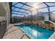 Relax in a screened in pool featuring lounge seating and a basketball hoop at 2850 Bookmark Dr, Kissimmee, FL 34746