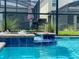 Close-up of a vibrant pool with a bubbling spa and lush landscaping, creating a serene and inviting atmosphere at 2850 Bookmark Dr, Kissimmee, FL 34746