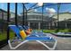 Screened-in pool and spa area with lounge chairs, ideal for soaking up the sun at 2850 Bookmark Dr, Kissimmee, FL 34746