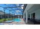 Beautiful screened-in pool and hot tub with outdoor dining and seating perfect for entertaining or relaxing at 2850 Bookmark Dr, Kissimmee, FL 34746