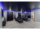 Cozy theater room with plush seating, a large screen, and ambient lighting for an immersive experience at 2850 Bookmark Dr, Kissimmee, FL 34746