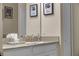Bathroom vanity with double sinks, elegant decor, and well-lit mirror at 2907 Fable St, Kissimmee, FL 34746