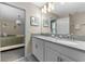 Bathroom features double sinks with modern fixtures, a large mirror, and decorative wall art at 2907 Fable St, Kissimmee, FL 34746