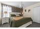 Cozy bedroom with a queen-sized bed, patterned wallpaper, and ample natural light at 2907 Fable St, Kissimmee, FL 34746