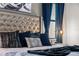Luxurious bedroom featuring a tufted headboard, plush pillows, and designer bedding at 2907 Fable St, Kissimmee, FL 34746