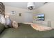 Well-lit bedroom featuring a queen-sized bed, soft pillows, and a mounted television at 2907 Fable St, Kissimmee, FL 34746