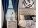 Luxurious bedroom with a tufted headboard, stylish bedside table, and elegant decor at 2907 Fable St, Kissimmee, FL 34746