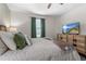 Bright bedroom featuring a queen-sized bed, warm decor, and a mounted television at 2907 Fable St, Kissimmee, FL 34746