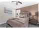 Cozy bedroom featuring a comfortable bed, lamps, and neutral tones at 2907 Fable St, Kissimmee, FL 34746