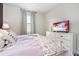 Light and airy bedroom featuring a large bed, a dresser with television, and bright natural light at 2907 Fable St, Kissimmee, FL 34746