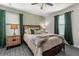 Comfortable bedroom featuring a queen-sized bed, hardwood floors, and modern decor at 2907 Fable St, Kissimmee, FL 34746