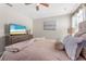 Comfortable bedroom featuring a television, lamps and neutral walls and textures at 2907 Fable St, Kissimmee, FL 34746