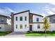 Contemporary two-story home with a modern design, featuring sleek lines, a stone accent wall, and well-manicured landscaping at 2907 Fable St, Kissimmee, FL 34746