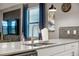 Modern kitchen featuring a quartz countertop, stainless steel faucet, and sleek backsplash at 2907 Fable St, Kissimmee, FL 34746