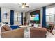 Cozy living room featuring a large TV, stylish furnishings, and ample natural light at 2907 Fable St, Kissimmee, FL 34746