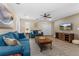 Bright living room featuring modern decor, plush blue seating, and a sleek entertainment center at 2907 Fable St, Kissimmee, FL 34746