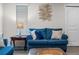 Inviting living room with blue sofa, decorative art, and a cozy ambiance at 2907 Fable St, Kissimmee, FL 34746