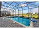 Relax in this screened-in pool and spa with a basketball hoop, overlooking a manicured backyard and a serene pond at 2907 Fable St, Kissimmee, FL 34746