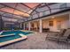 Relaxing screened-in pool area with a spa, backyard view, and patio seating, perfect for outdoor enjoyment at 2907 Fable St, Kissimmee, FL 34746