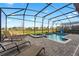 Enjoy this relaxing screened-in pool and spa with a beautiful view of the manicured backyard and landscaping at 2907 Fable St, Kissimmee, FL 34746
