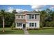 Charming two-story home featuring a modern exterior design with well-manicured landscaping and inviting entrance at 3017 Namaste Dr, Clermont, FL 34714