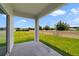 The home features a covered back patio overlooking a lush, green lawn and privacy fence at 311 Eaglecrest Dr, Haines City, FL 33844