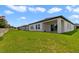 Spacious backyard with a well-maintained lawn and covered patio, perfect for outdoor activities and relaxation at 311 Eaglecrest Dr, Haines City, FL 33844