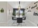 Dining room with modern light fixture, marble-topped table, black chairs, and wall decor with inspirational sayings at 311 Eaglecrest Dr, Haines City, FL 33844