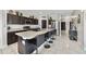 Contemporary kitchen featuring stainless steel appliances, center island, and dark wood cabinets at 311 Eaglecrest Dr, Haines City, FL 33844