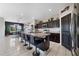 Bright kitchen with a large island, bar stool seating, stylish lighting, and modern appliances at 311 Eaglecrest Dr, Haines City, FL 33844