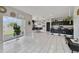 Open-concept living area featuring tile floors, a kitchen with bar seating, and a sliding glass door to the backyard at 311 Eaglecrest Dr, Haines City, FL 33844