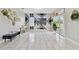 Spacious living room showcasing white marble floors, a wall-mounted TV, and a sliding glass door at 311 Eaglecrest Dr, Haines City, FL 33844