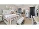 Cozy bedroom with a white bed frame, neutral walls, carpet, and access to a private bathroom at 311 Eaglecrest Dr, Haines City, FL 33844