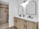 Bathroom featuring a double vanity, arched mirrors, and glass-enclosed shower at 3153 Greenwood St # Winter Spr, Winter Park, FL 32792