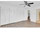 Bright bedroom with hardwood floors and wall-to-wall closets at 3153 Greenwood St # Winter Spr, Winter Park, FL 32792