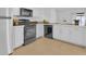 Contemporary kitchen with white cabinets, a black dishwasher, and a stainless steel refrigerator at 3153 Greenwood St # Winter Spr, Winter Park, FL 32792