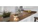 Close-up of a kitchen sink and counter highlighting stainless steel fixtures and tile countertops at 3153 Greenwood St # Winter Spr, Winter Park, FL 32792