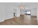 A bright living room with hardwood floors, modern lighting, and an open layout to the kitchen at 3153 Greenwood St # Winter Spr, Winter Park, FL 32792