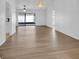Open living room with new hardwood flooring, modern light fixtures, and sliding glass doors to the lanai at 3153 Greenwood St # Winter Spr, Winter Park, FL 32792
