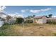 Spacious backyard with shed, trees, and partially fenced perimeter at 316 Bennett St, Auburndale, FL 33823