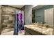 Bathroom featuring a shower with grey tile surround and glass door at 316 Bennett St, Auburndale, FL 33823