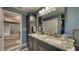 Modern bathroom vanity with dual sinks, granite countertop, and dark cabinets at 316 Bennett St, Auburndale, FL 33823